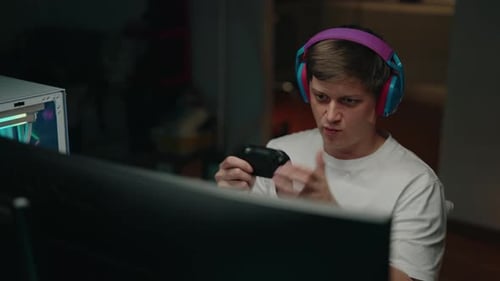 Excited Young Man Plays Video Game at Home