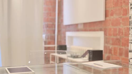 African Man Coming to Office and Starting Work on Laptop