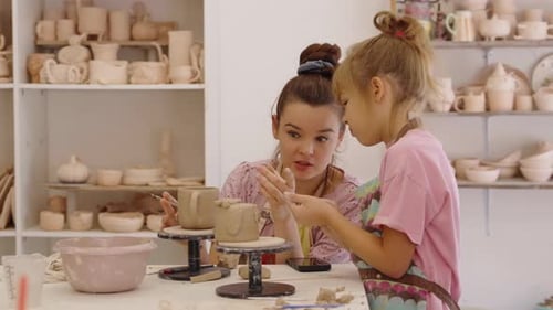 Young Artists Creating Pottery Together in a Ceramics Studio