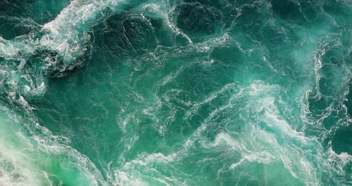 Blue waves of water of the river and the sea meet each other during high tide and low tide.