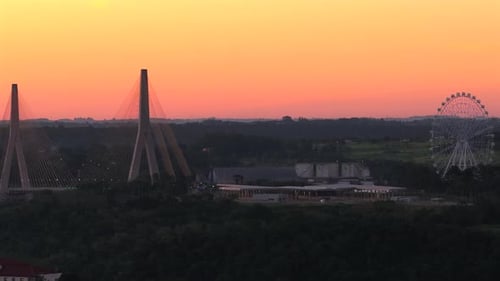 Integration Bridge with cable stayed towers and the Three Borders Landmark with Ferris wheel near