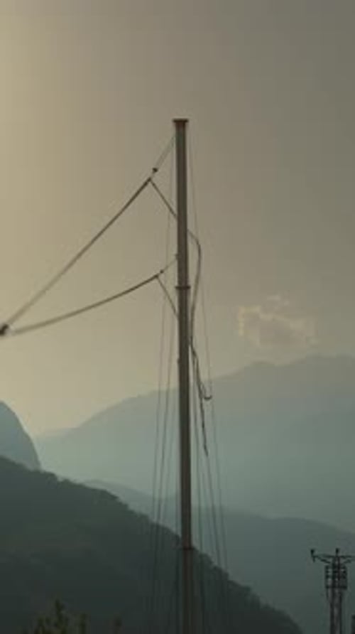 Vertical video. Feeling Freefall from a Mountain Against the Backdrop of a Sunset. A Tourist Spot.