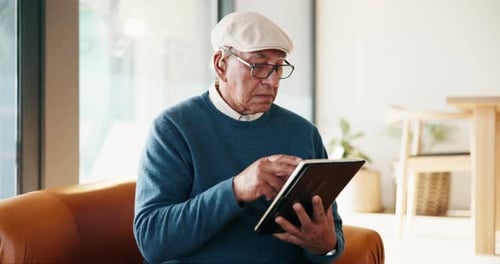 Senior Man Using Tablet at Home
