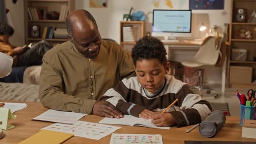 Loving Black Father Encouraging Son Learning to Write by Hand