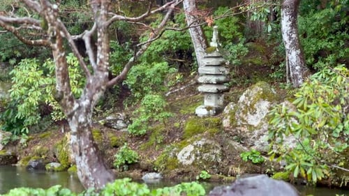 Stone Pagoda In Garden Of Konchi-in Temple With Raindrops Falling. Kyoto, Japan. static shot
