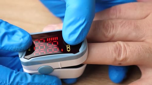 Close-up of Fingertip Pulse Oximeter in Use