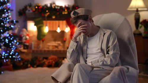 Contemplative Young Adult near Christmas Tree