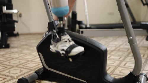 Man with Prosthetic Leg Using Stationary Bike