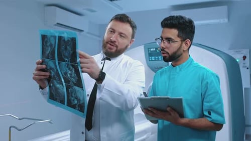 Doctors Examining Medical Scan in Modern Hospital