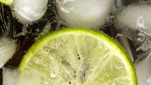 Refreshing Lime Slice in Fizzy Drink with Ice