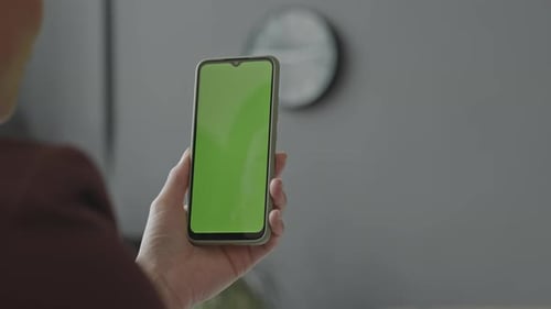 Woman Holding Smartphone with Green Screen