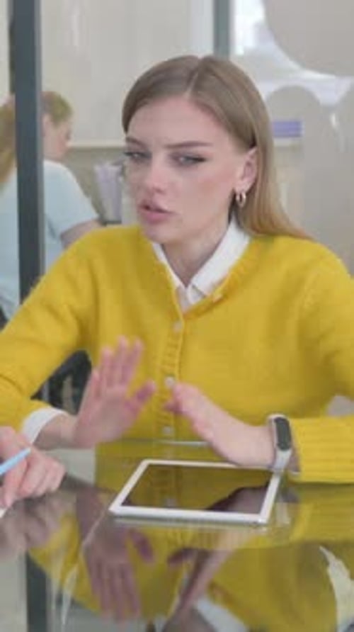 Young Woman Working at a Table with Tablet