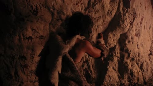 Primitive Man Drawing Animal Images in Cave