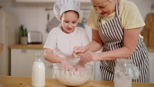Grandmother and Child Baking Together in Kitchen