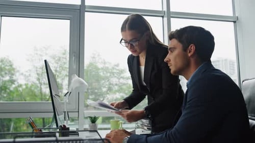 Project managers discussing financial data at the office close up