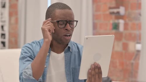 Man Reacts to Tablet News Indoors