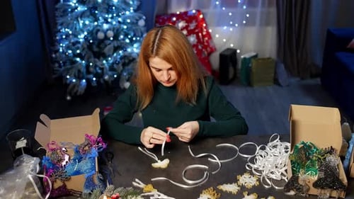 A Woman Makes Christmas Decorations in Her Home Workshop