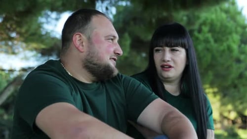 Romantic Young Couple Talking Together Outdoors in a Park