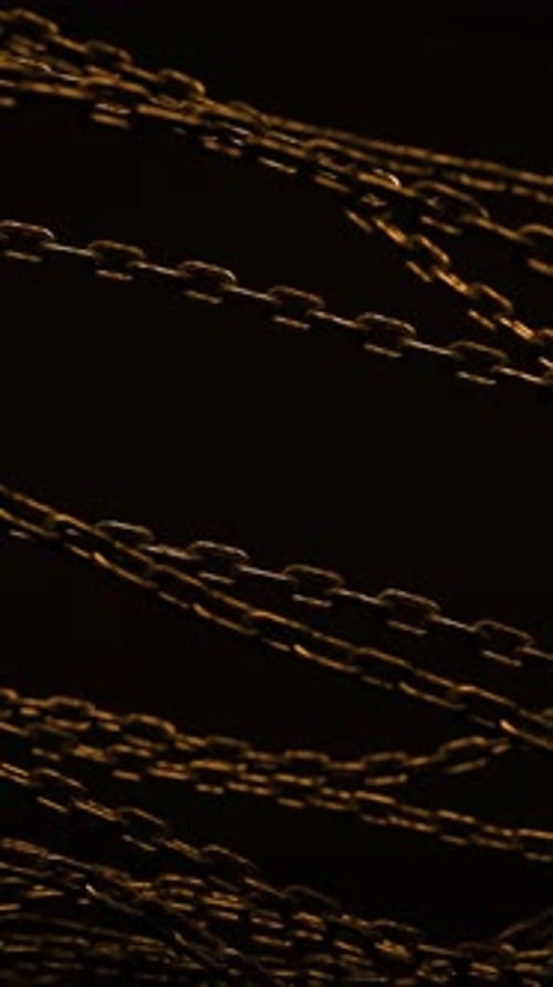Animated Golden Chains Swirling in Dark Background