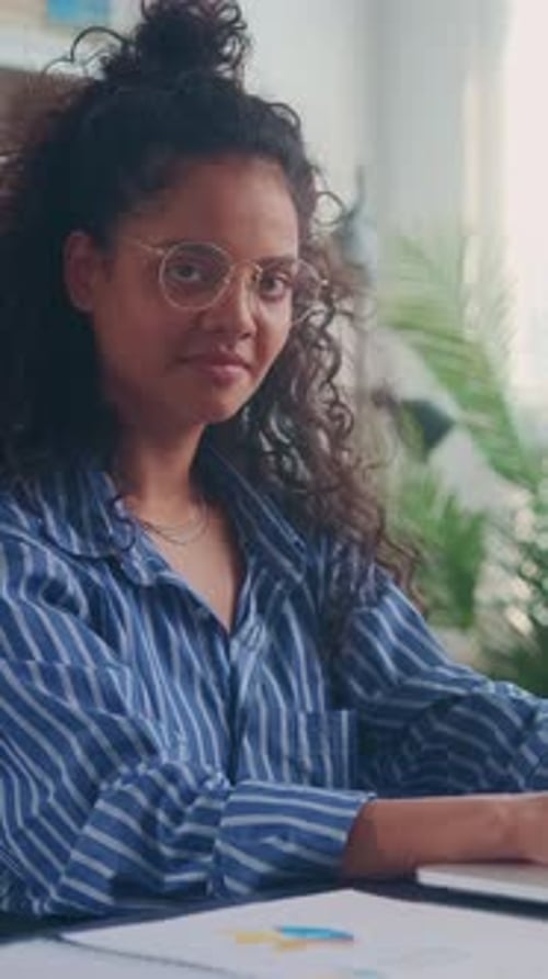 Young Woman Working on Laptop in a Bright Home Office