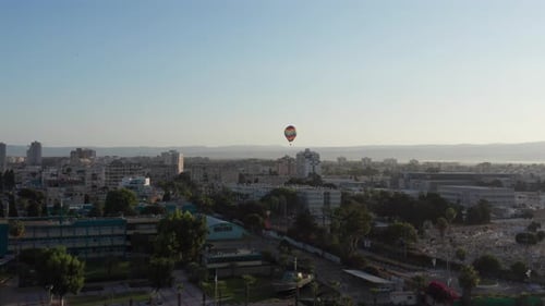 Hot air balloon passing over Acre old city port houses and Mosque at sunrise, Aerial view