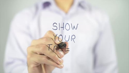 Man Writes Show Your Talent on Glass Surface
