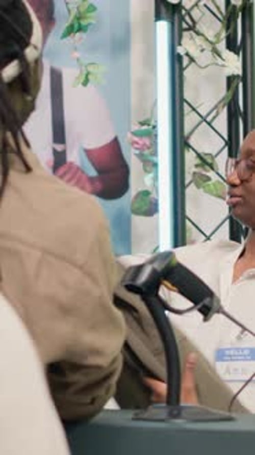 Vertical Video Client Buys Clothes at Checkout Counter