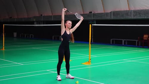 Sports Young Woman with Racket and Shuttlecock is Exercising Doing Warmup Before Playing in
