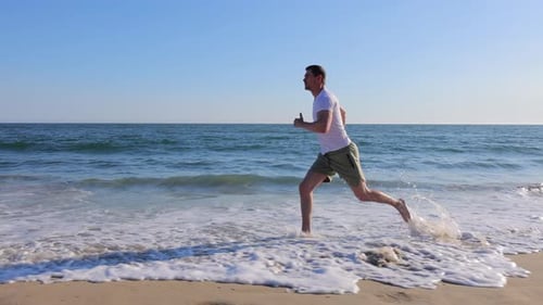 Athletic Man Exercising At The Beach