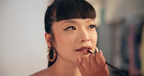 Woman Applying Lip Color with Brush, Close Up