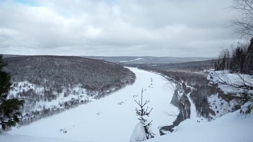 Paysage hivernal d'une rivière large et froide. Pince. Paysage gelé avec forêt et rivière sinueuse.
