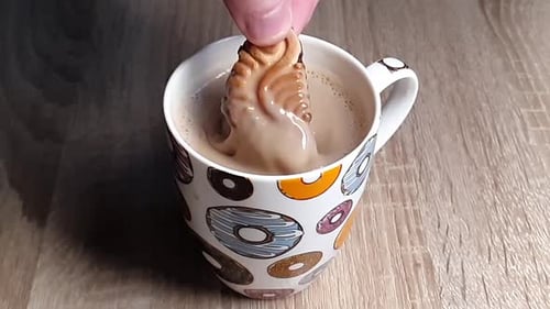 Cookie Dipped Into Mug of Refreshments