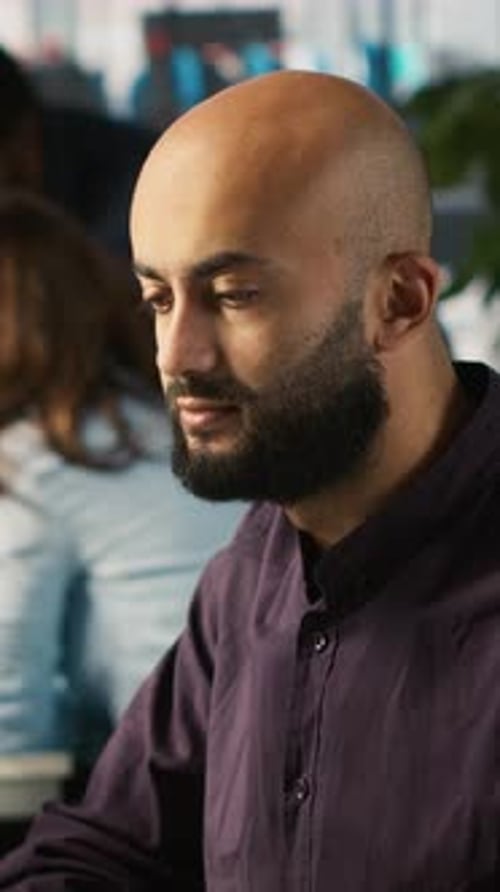 Vertical Video Happy Man in Office Reviewing Financial Graphs Celebrating Positive KPIs