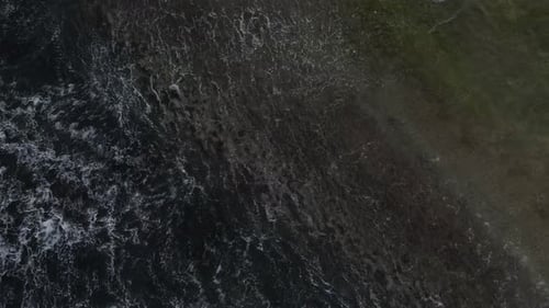 A bird's eye view footage of the open waters with various waves and sea foam. The aerial footage sta