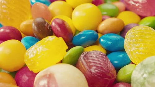 Colorful Dragee Candies Lollipops Bonbons on White Background Move in Circle Side View Closeup