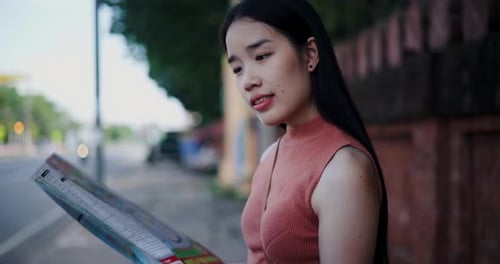 Woman Looks at Sign in Urban Setting