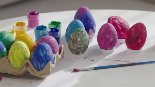 Painted Easter Eggs and Craft Paint on Table