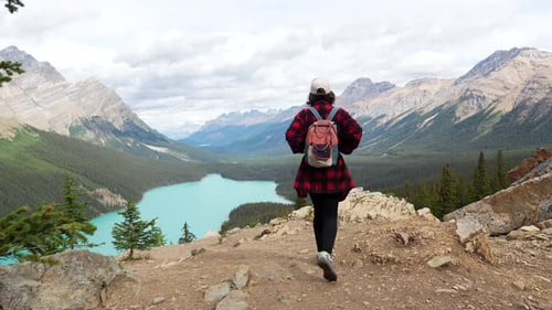 Woman hiking towards scenic view of peyto lake in banff national park