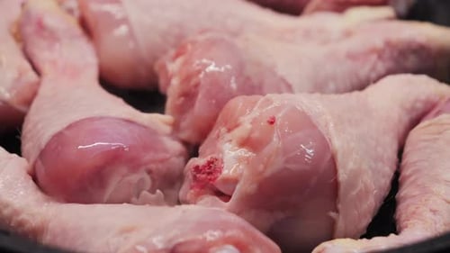 Cooking Chicken Legs in a Frying Pan at Home