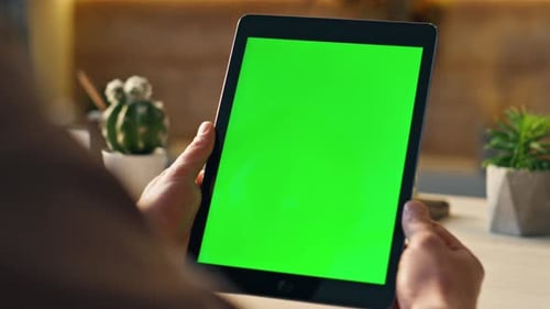Unknown Freelancer Looking on Green Screen Digital Tablet Sitting Work Desk Close