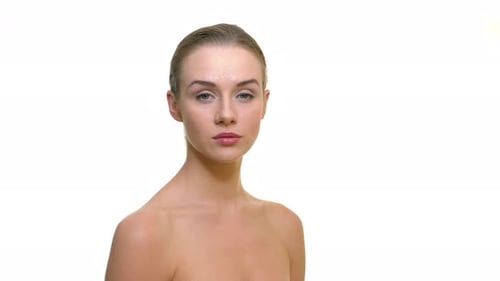Portrait of young beautiful naked women on a white studio background