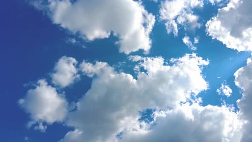 Clouds Floating Gently Across a Bright Blue Sky