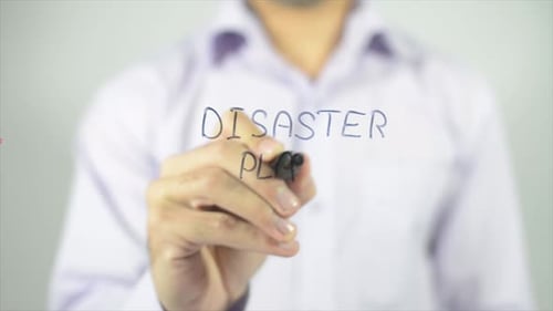 Person Writes Disaster Plan with Marker