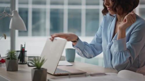 Tired Worker Closing Computer Feeling Unmotivated at Office Desk Closeup