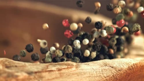 A Handful of Peppecorn Falls Into a Mortar Filmed on a Highspeed Camera at 1000 Fps
