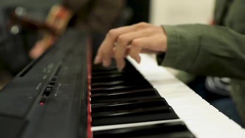 Female hands tuning the piano to play on it in the studio - close up