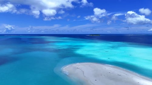 Clouds pass over an island with crystal water. Maldives