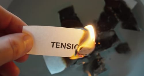 Burning paper with word tension