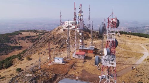 Telecommunications station with several antenna towers. Orbital aerial view.