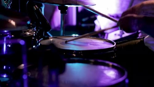 Drummer playing the drums at a rock concert. Live performance of a drummer at a music festival.